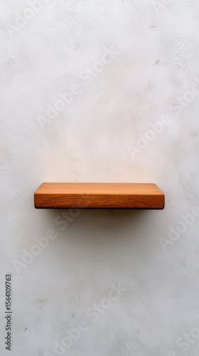 Simple Wooden Shelf Against Textured Light Wall Surface