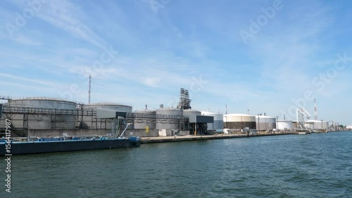 Antwerp, Belgium - June 20, 2025: Storage tanks,  refinery and ships in the port of Antwerp, Belgium