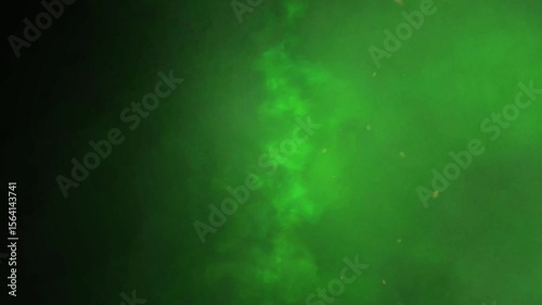 Emerald green mist creates a mysterious atmosphere in a space or dark backdrop for design purposes.