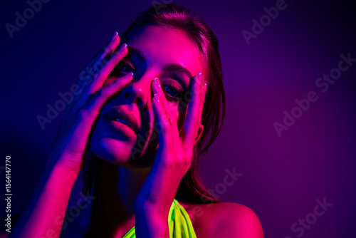 Portrait of a young woman with neon lighting and vibrant colors in a creative and fashionable style