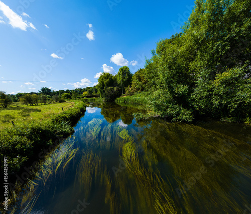 Aerial shot flying low down a Chalk River in Wiltshire, UK