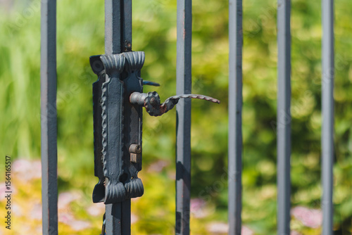 Close-up of Vintage Iron Gate Handle in Sunny Garden
