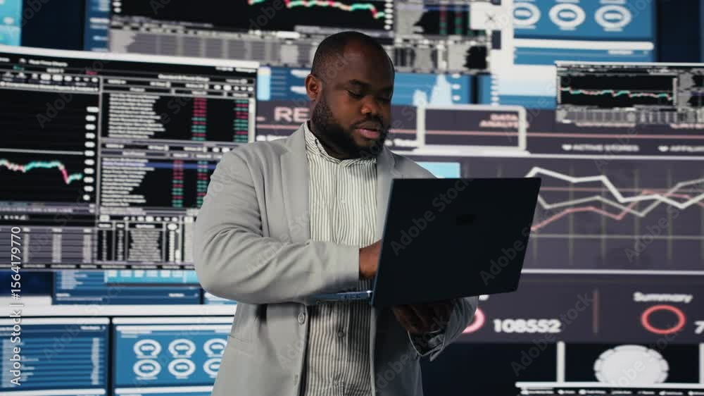 African american entrepreneur browsing his laptop to check infographics, reviewing new growth strategy to increase the company revenue. Fintech insight with digital tools. Leadership. Camera B.