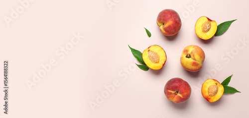 Sweet peaches and leaves on beige background
