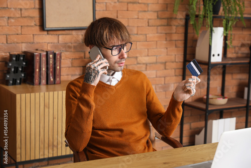 Young man with credit card ...