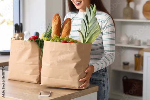 Young Asian woman with mobi...