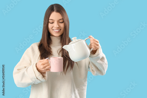 Young woman pouring tea int...