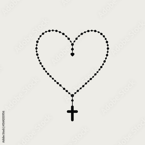 Black rosary beads forming a heart shape with a cross pendant