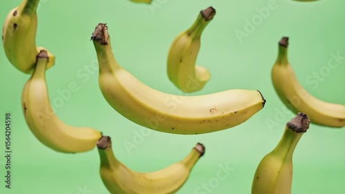 Bananas floating against green background