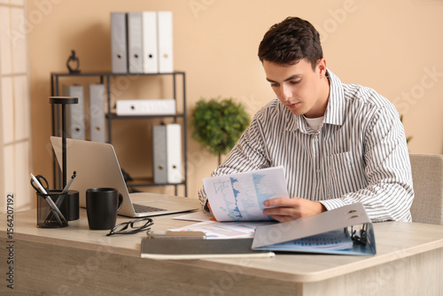 Male economist working with...