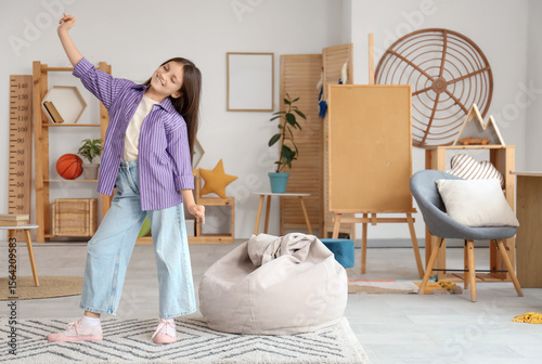 Teenage girl dancing at home