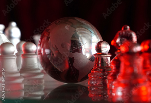 Crystal planet Earth amidst chess pieces showing the American continent, representing concepts of geopolitics, global power, competition for control, international relations, world leaders, struggle f