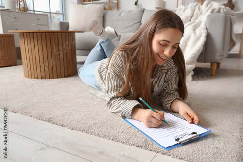 Young woman making to-do li...