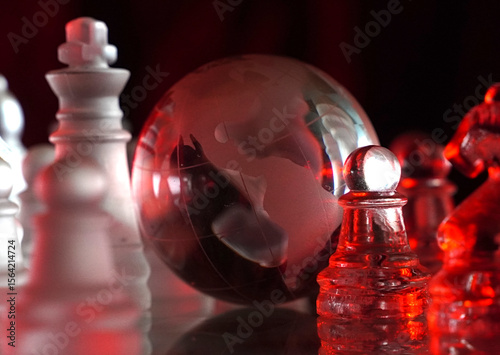 Crystal planet Earth amidst chess pieces showing the American continent, representing concepts of geopolitics, global power, competition for control, international relations, world leaders, struggle f