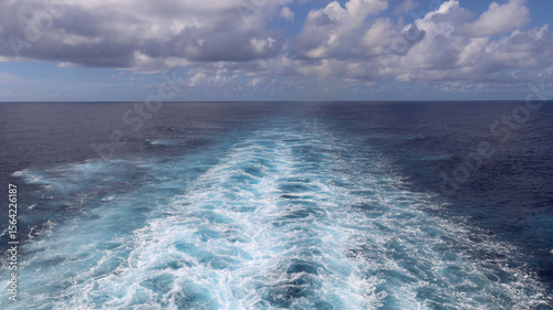 Ocean perspective behind sailing cruise ship