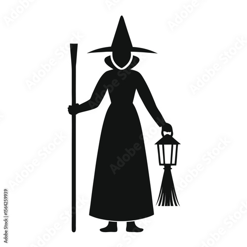Silhouette of a witch in a robe holding a lantern and walking stick shown