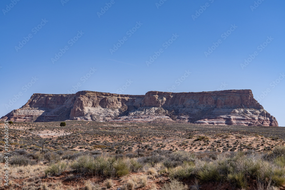 Fototapeta premium LeChee Rock is a sandstone feature located south of Lake Powell, in Coconino County of northern Arizona. A mesa is an isolated, flat-topped elevation, ridge, or hill. 
