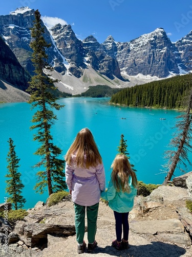 Wallpaper Mural Woman and girl holding hands standing in front of turquoise Moraine Lake and mountains in Banff Torontodigital.ca