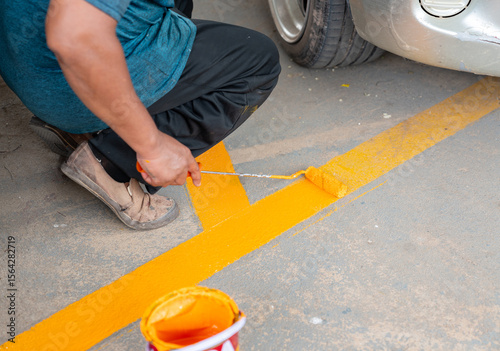 Workers are repainting the parking space markings.