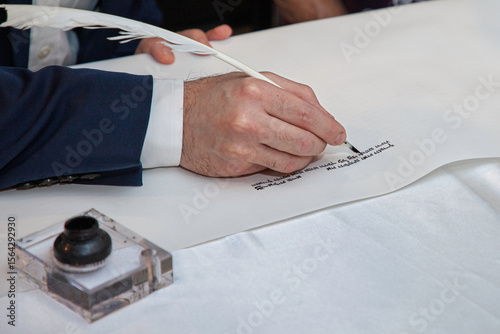 Rabbinical sofer, or scribe, starts the long process of creating a Torah scroll by hand