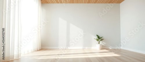 Empty room with light gray textured wall and light wood flooring
