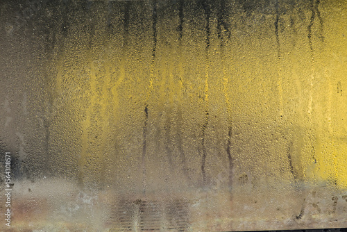Dew drop on the car glass window during raining. Dew is the moisture that forms as a result of condensation. Close up view.