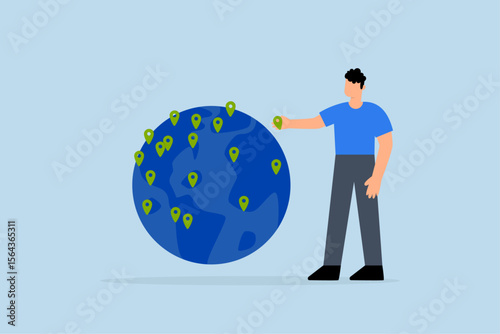 businessman CEO put new branch pin on world map across globe.