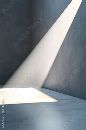 Minimalist room interior with soft beam of natural light illuminating a white triangular shape on a light gray wall. Modern geometric design with clean lines and calm atmosphere