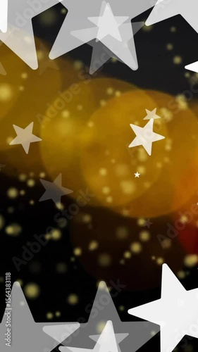 Animation of white stars over orange and yellow light spots on black background