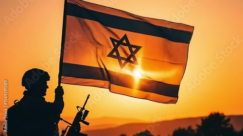 Military person holding a waving israel flag silhouetted against a vibrant orange sunset sky