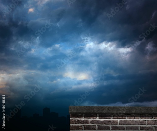Brick wall against cloudy sky at dusk
