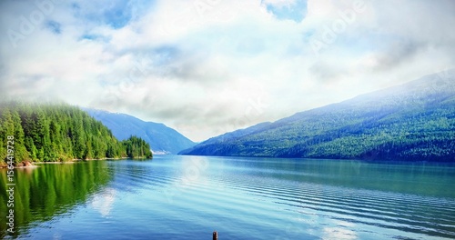 River amidst mountains against cloudy sky
