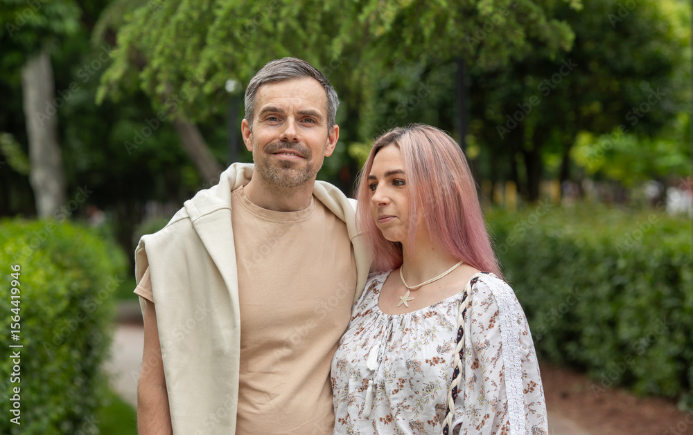 Fototapeta premium A man and a woman are standing in a park