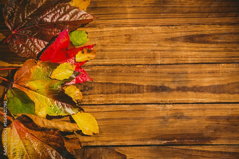 Naklejka premium Wooden table with autumn leaves