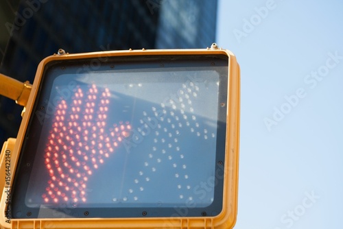 Illuminated road sign against sky