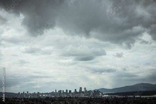 Cityscape against cloudy sky