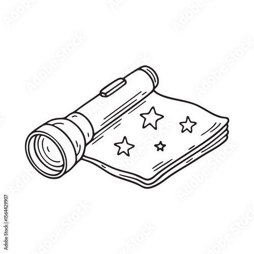 A folded star chart placed on a blanket beside a flashlight