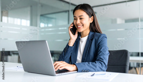 Business woman using laptop computer typing in modern office. 