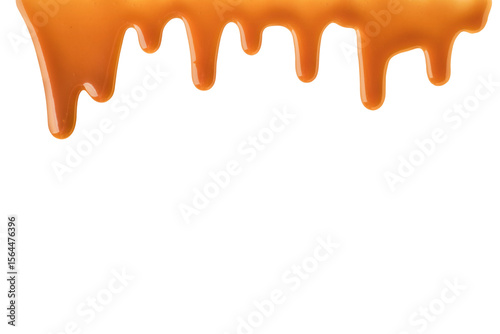 Melted caramel sauce drips down frame on transparent background