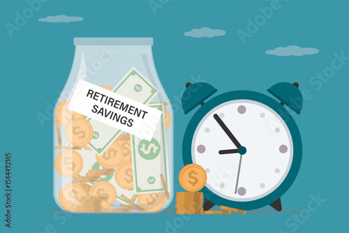 Glass jar bottle labeled as retirement savings with full of coins and banknotes, alarm clock as savings or investing for retirement concept. Pension fund.
