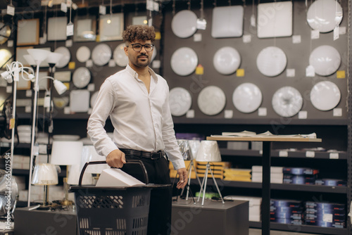 Man Exploring Home Lighting Options in a Modern Store with Samples Displayed