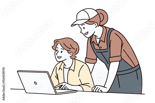 Two people collaborating on a laptop computer one person is pointing at the screen while the other looks on attentively