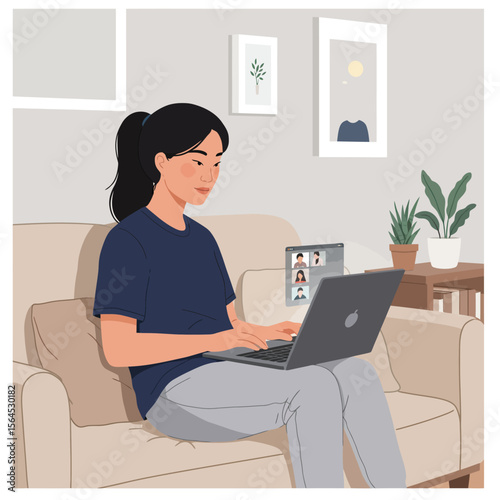 A young woman sits on a beige couch in a light-filled living room, working on her laptop and participating in a video conference call with colleagues.