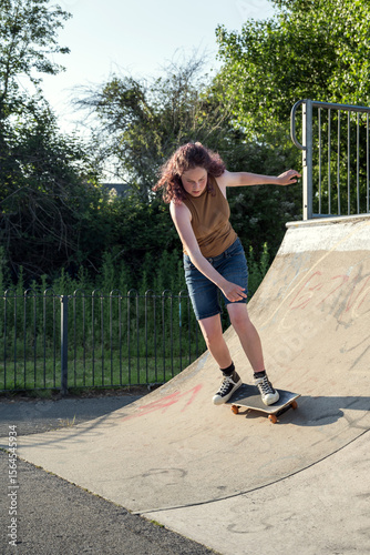 Young girl riding on her skateboard, outdoor kids activities