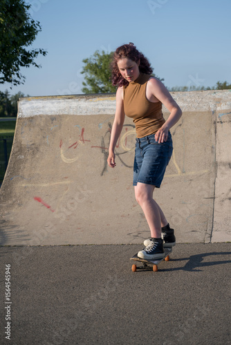 Young girl riding on her skateboard, outdoor kids activities