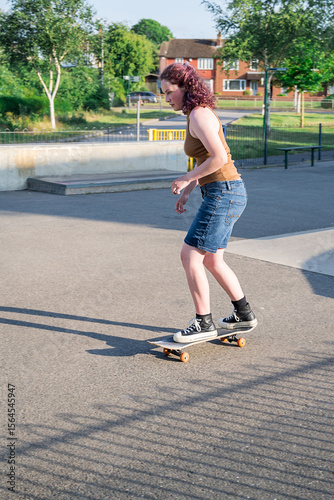 Young girl riding on her skateboard, outdoor kids activities
