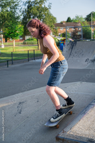 Young girl riding on her skateboard, outdoor kids activities