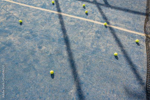 balls in a padel tennis court at sunset