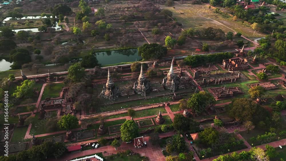 Medium distance drone view of Three Main Stupas in Wat Phra Si Sanphet surrounding ancient temple structures in Historical Park