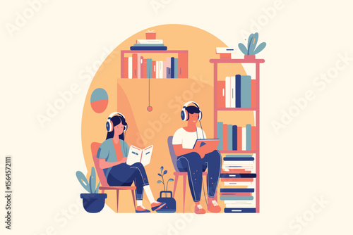 Two students wearing headphones are reading and studying together in a comfortable library space.